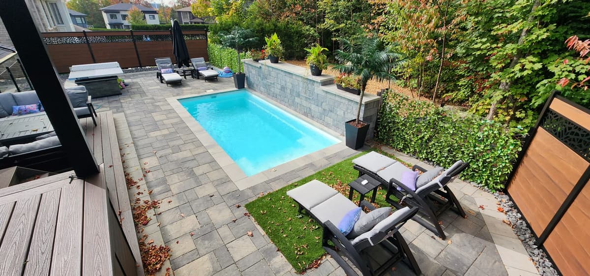 Residential landscaping work with pavers and green spaces in Quebec