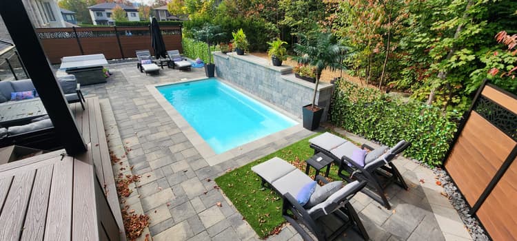 Residential landscaping work with pavers and green spaces in Quebec
