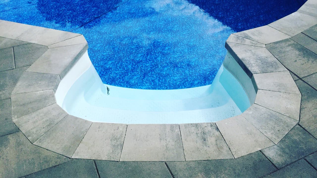 detail of the paved pool surround around the swimming area